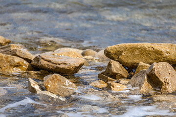 The rough Adriatic Sea in Croatia, waves lapping the stones on the beach Rab Croatia