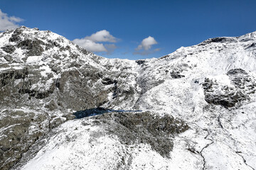 Campagneda pass and Campagneda lake in Valmalenco, drone view after snowfall