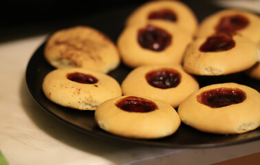 Homemade round cookies filled with strawberry jam.