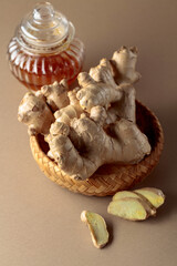 Ginger with honey jar on a beige background.