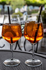 Two glasses of alcoholic spritz, on an outside table in Bellagio