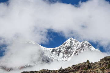 Among the clouds, Piz Argient and Piz Zupò in the Bernina massif