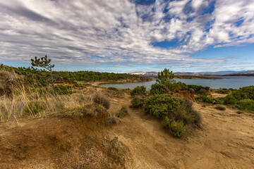 Scenic Mediterranean Landscape with Rocky Coastline, Green Bushes, and Dramatic Sky Rab Croatia