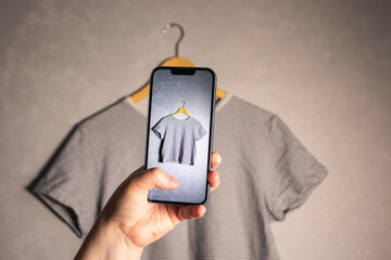 Female influencer prepares used garments for resale. Online second hand shop. Fashion circulation.