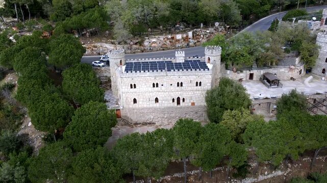 Aerial view of Moussa Castle, a famous historical landmark and museum located near Deir el Qamar, Lebanon, surrounded by forested mountains. 