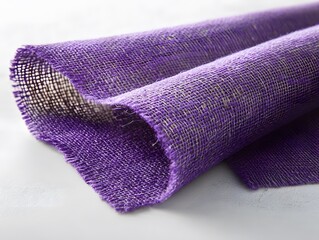 Rolled purple burlap fabric on white background for art craft texture backdrop