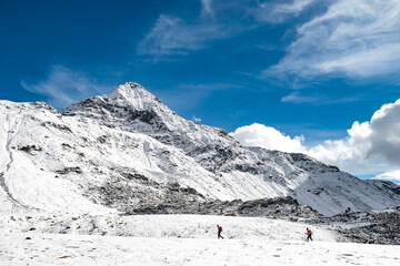 Hiking on snow with Pizzo Scalino on background, Central Alps, Italy landscape