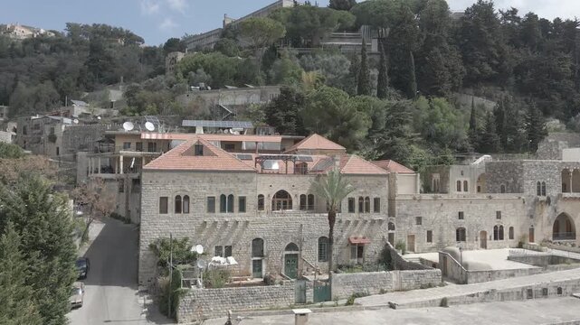 Aerial view of the historic main square in Deir el Qamar, Lebanon, surrounded by traditional stone buildings, houses, and cultural landmarks. 