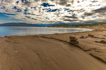 Scenic Mediterranean Landscape with Rocky Coastline, Green Bushes, and Dramatic Sky Rab Croatia