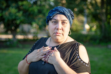 Portrait of a woman finding solace in her religious beliefs