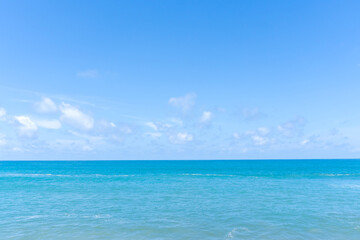 Deep blue sea with blue sky and thin fluffy clouds taken at the sea in Phuket South of Thailand used as blue natural background texture
