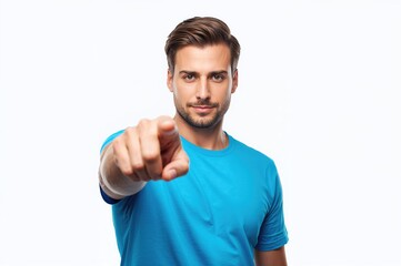Young man with short hair wearing a blue t-shirt pointing directly at the camera with a confident expression against a plain white background