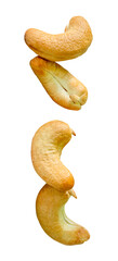 A set of four roasted or baked cashew nuts in two heaps isolated on white background with clipping path
