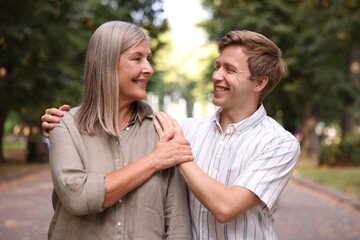 Fototapeta premium Smiling mother and her son in park. Family bonding
