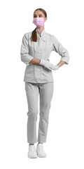 Full-length portrait of nurse in uniform and medical mask on white background