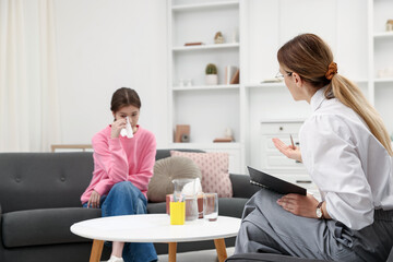 Professional psychologist working with teenage girl in office