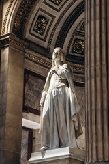 Paris, France - September 10, 2025: Marble statue inside the Church of La Madeleine with detailed architectural background