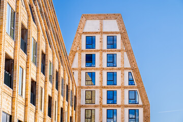 Futuristic glass building against blue sky, Copenhagen, Denmark. Scandinavian modern architecture on paper island (Papirøen København).