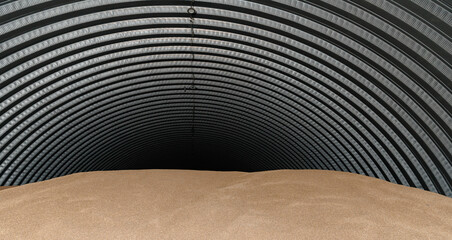 Warehouse metal grain storage shed filled with wheat for agricultural use