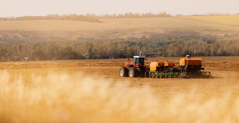 Tractor cultivating field in rural countryside landscape