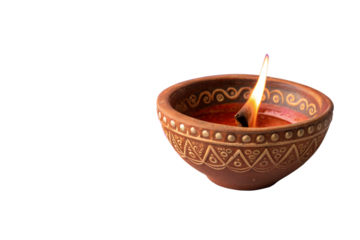 Photo of a traditional clay diya with a burning flame, isolated on a transparent background, symbolizing light and celebration during festivals like diwali
