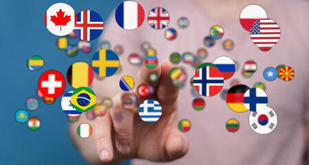 A hand touching floating flags of various countries, symbolizing global connection, travel, and international cooperation.
