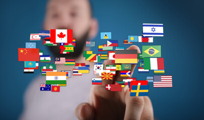 Conceptual image of a hand touching a collection of flags representing various countries, perfect for travel, global business, or international