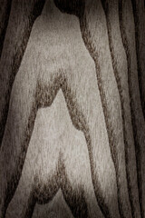  gray background is made of old wood. an old board. the texture of a rustic table. ash tree, a place for a text or object, frame, vignetting, view from above. the effect of aging, vertical, close-up.