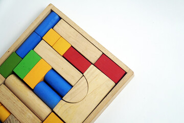 A vintage wooden box filled with a variety of building blocks in different shapes and colors. This image is perfect for concepts of childhood, learning, games, and retro toys.


