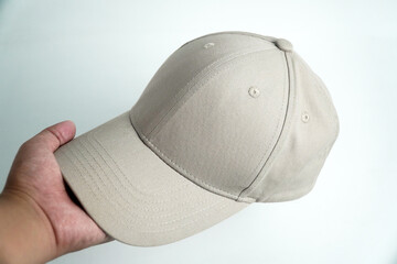 A hand holds a blank gray baseball cap, presenting it against a clean white background. This versatile image is perfect for mockups, clothing, or accessory concepts.