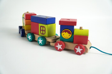 A colorful wooden toy train with blocks of different shapes and numbers, isolated against a white background. This image is perfect for concepts of childhood, learning, games, and vintage toys.

