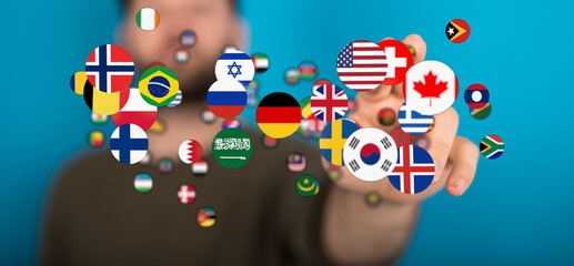 A hand reaching out to touch flags of the world. Representing global unity, international travel, and interconnectedness. Perfect for illustrati