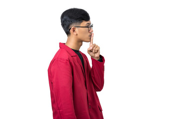 Young college student shushing gesture with finger on lips isolated on white background