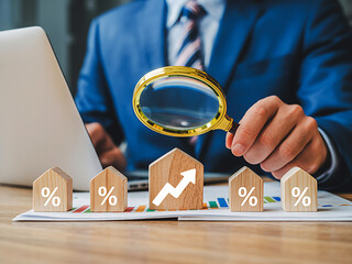 Professional businessman analyzing real estate market trends and interest rate increases with magnifying glass, showcasing financial growth strategies for investment