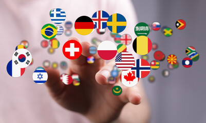 Conceptual image of a hand interacting with multiple international flags, symbolizing global connections, unity, and cultural diversity. Represe