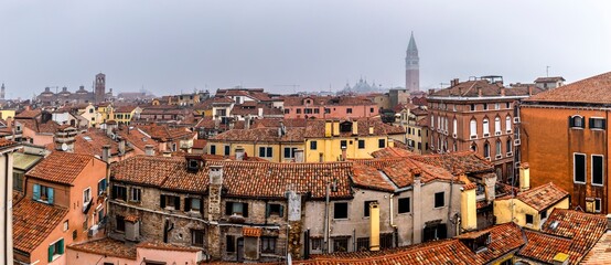 Venice, Italy - February 8, 2025: Aerial view on the roofs of Venice with St Marks Basilica in background