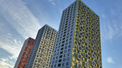modern cityscape with tall buildings featuring glass facades. These structures likely represent a new urban development project, possibly including office spaces, residential units, and commercial are