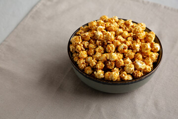 Homemade Caramel Pop Corn in a Bowl, low angle view. Copy space.