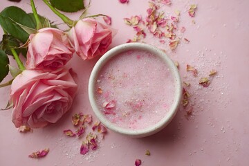 Pink rose body scrub on a pink background, natural skincare product made from roses, exfoliating and refreshing, beauty and self-care concept with copy space for text