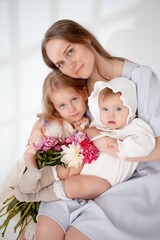 mother with children, with little daughters on a white isolated background, space for text, mother and child