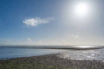 Obraz premium beautiful deserted beach at Hill Head Hampshire England with blue sky and white fluffy clouds in the background