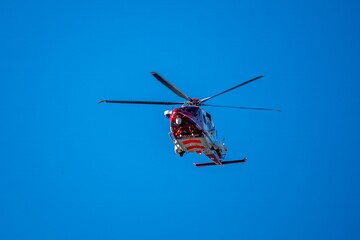 Fototapeta premium Hill Head England -February 22 2022: coastguard Helicopter airborne with blue sky in the background
