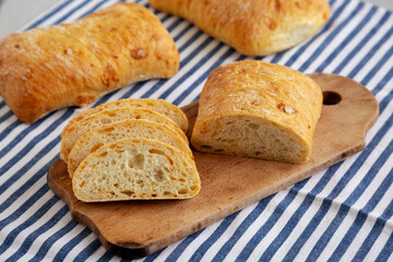 Homemade Cheese Ciabatta Bread on a Wooden Board, side view.