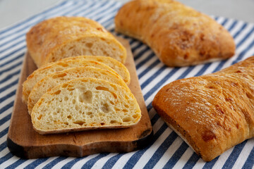Homemade Cheese Ciabatta Bread on a Wooden Board, side view.