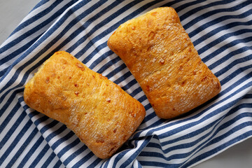 Homemade Cheese Ciabatta Bread on a Wooden Board, top view.