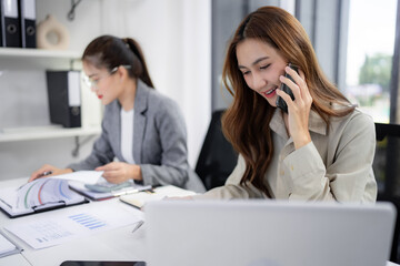 Asian adult businesswomen office communication work consulting reviewing reports analyzing data...