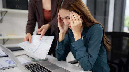 Asian adult businesswomen experience workplace stress office setting reviewing difficult financial reports discuss challenging business problems project deadlines team collaboration pressure