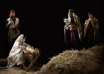 Mary sits in the stable near the manger with the baby