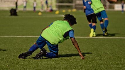 youth football player getting up after being tackled