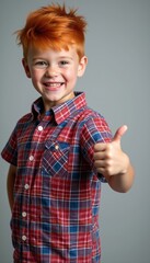 Cheerful boy with red hair giving a thumbs-up